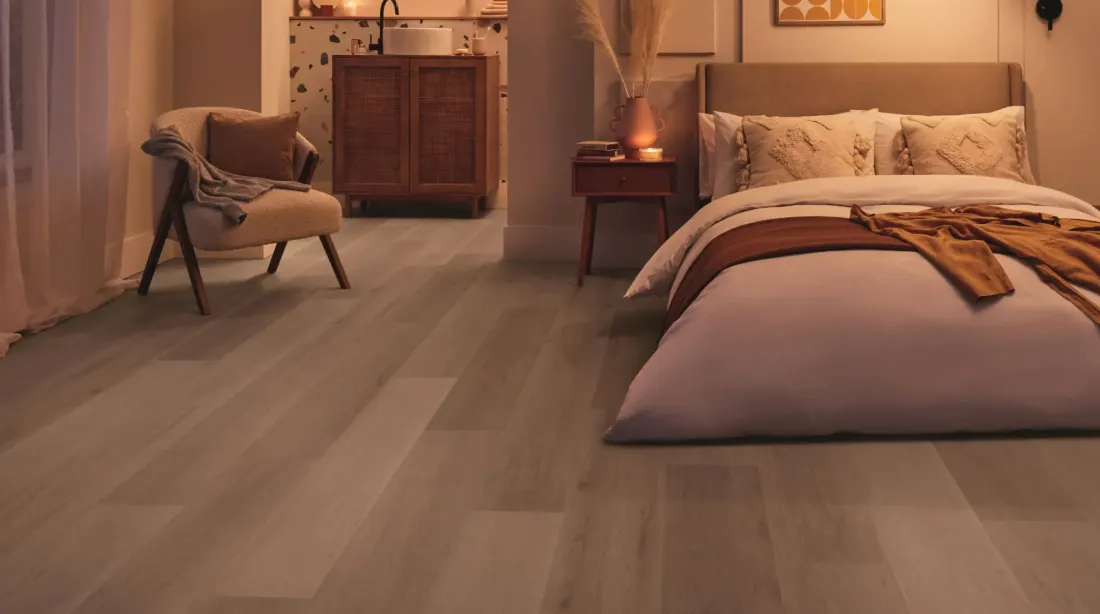 Grey oak-look vinyl plank flooring in a bedroom, Camberwell Floorworld